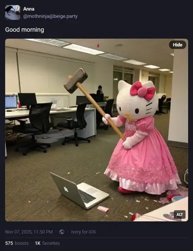 Meme photo. In a drab soulless office setting with depressing fluorescent lighting and depressing brown industrial carpet, a person in a Hello Kitty costume - an enormous white cat head with a pink bow on one ear and a pink sparkly dress - wields a sledgehammer at an open laptop on the floor at their feet.